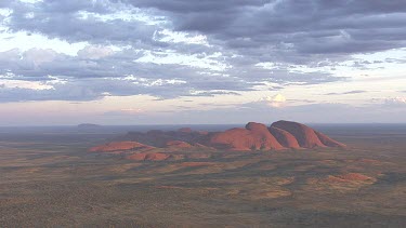 Red rocky cliff at dusk in Uluru-Kata Tjuta National Park