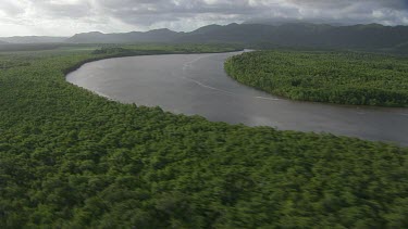 CM0001-NP-0030938 Aerial view of a sunlit, winding river through a forested landscape