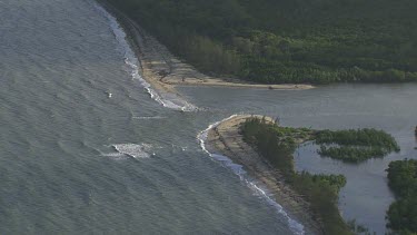 Aerial view of a winding river through a forested landscape