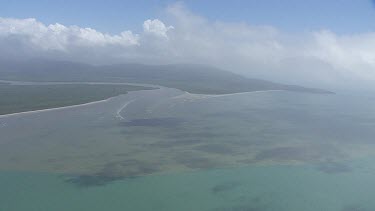 Aerial view of vegetation in the deep, cloudy ocean in Daintree National Park