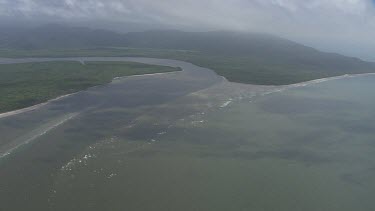 Aerial view of the ocean and a forested coast in Daintree National Park