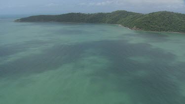 Aerial view of the ocean and a forested coast in Daintree National Park