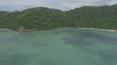 Aerial view of the ocean and a forested coast in Daintree National Park