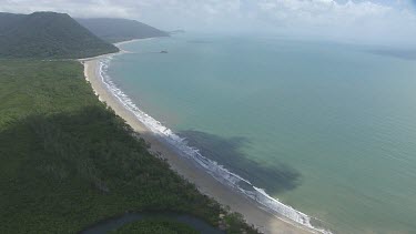 Aerial view of the ocean and a forested coast in Daintree National Park