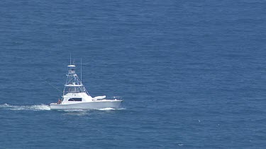 White boat travelling through the ocean in Daintree National Park