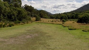 Aerial of Kosciuszko National Park -  Tracking through forest and river landcape