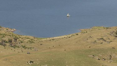 Aerial of Kosciuszko National Park Landcape - Sailing boat sailing along the river.