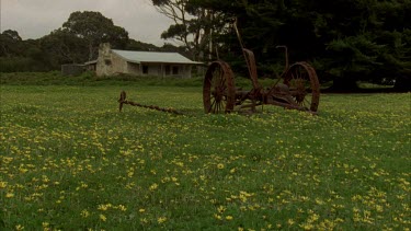 Daisies historic house with rusty rake in FG