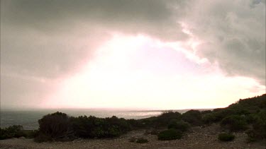 lighthouse on hill pan from coast to beacon