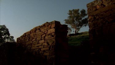 Stone wall of house ruins