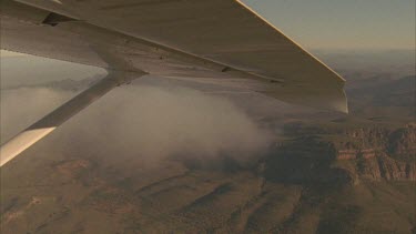 Wilpena Pound aerial. Wing of plane in foreground