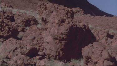 various conglomerates small rock boulders of Kata Juta weathered by sun and time vegetation in between Walla gorge