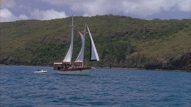 sailing boat yacht makes its way down coast of hook island