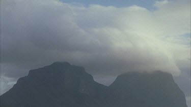 Clouds rolling over summit of Mt Gower and Mt Lidgbird, darkening dusk