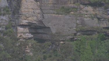 cable car going down between sandstone cliffs