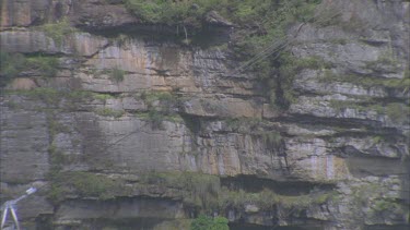 cable car going up between sandstone cliffs