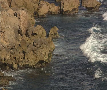 Coastal cliffs, erosion. waves. base of cliffs. Close up.
