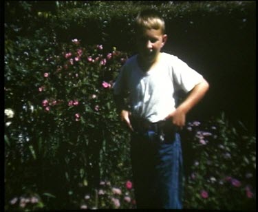 child takes small water pistols from trousers and shoots at camera