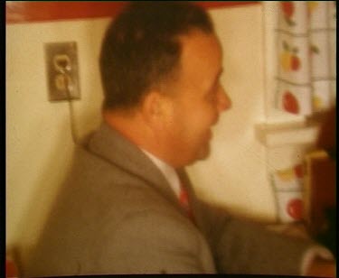 Two men playing cards in kitchen