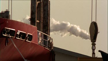 Docked ship loads cargo onto deck