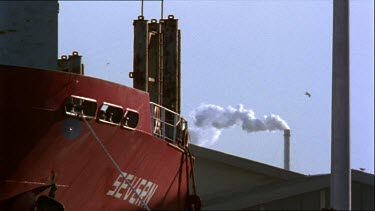 Docked ship loads cargo onto deck