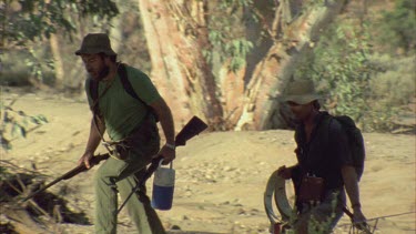 Two men walking through bush