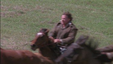 Riders galloping, cracking whip