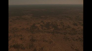 Overlooking Smaller Plane In The Sky Over The Australian Outback