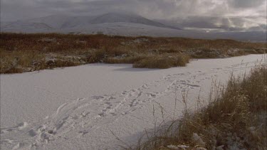 mist blowing over snow capped mountain