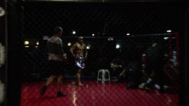 Fighters preparing for a full-contact fighting match in a ring