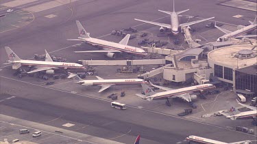 Airport (LAX?) American airline terminal. Jets. Boeings etc. runway.