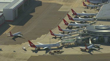 Airport (Sydney International?) QANTAS terminal. Boeings and jets etc.