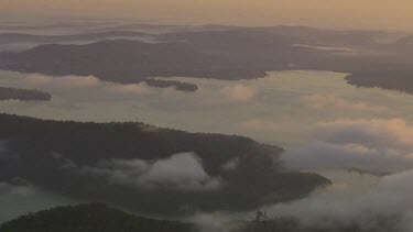 Misty scene. Harbour or waterway, inlets, bay. Low lying clouds.