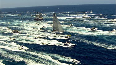 Sydney to Hobart Yacht race. Sydney Harbour. North Head, heading out to sea. Tall ship amongst yachts and speed boats.