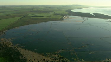 Salt mining and salt processing, manufacture Cheetham salt. Great Australian Bight. Salt produced by solar evaporation from saline or brine waters.  Small triangular mountains of salt scrapped up.