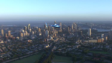 Sydney at sunrise. Helicopter and early morning light. Very blue light and metallic blue helicopter.