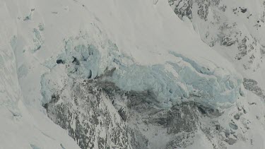 Could be glacial ice, blue compacted ice on mountain slope.