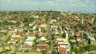 Aerial Bondi Beach, Sydney zoom out to see Sydney city, Harbour Bridge and harbour in background