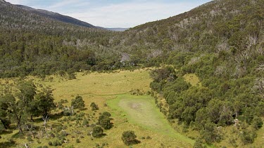 Aerial of Kosciuszko National Park -  Tracking through forest and river landcape