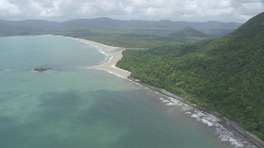 Aerial view of the ocean and a forested coast in Daintree National Park