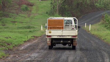 Trucks carrying captured cassowaries from urban areas drive away. The birds will be relocated to rainforest areas.