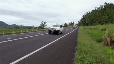 Trucks carrying captured cassowaries from urban areas drive away. The birds will be relocated to rainforest areas.