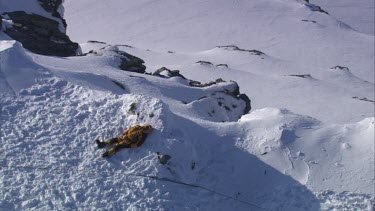 Aerial of Mount Everest: Climber in laying in snow.