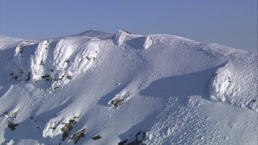 Aerial of Mount Everest: Climber in laying in snow.