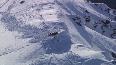 Aerial of Mount Everest: Climber in laying in snow.