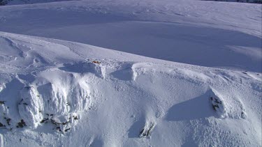 Aerial of Mount Everest: Climber in laying in snow.