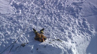 Aerial of Mount Everest: Climber in laying in snow.