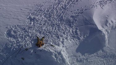 Aerial of Mount Everest: Climber in laying in snow.