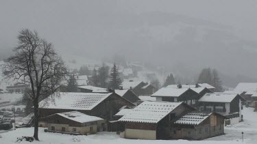 Snow falling on the alpine village of Notre Dame de Bellecombe
