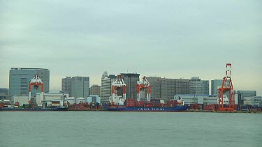 Unloading a freight ship in Odaiba harbour, Tokyo